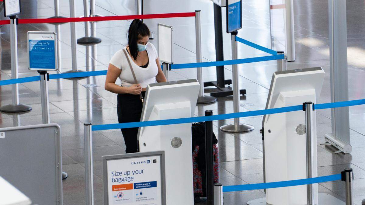 A traveler checked into a flight at Dwight D. Eisenhower National Airport in November 2020. See how air travel in Kansas has changed since then.