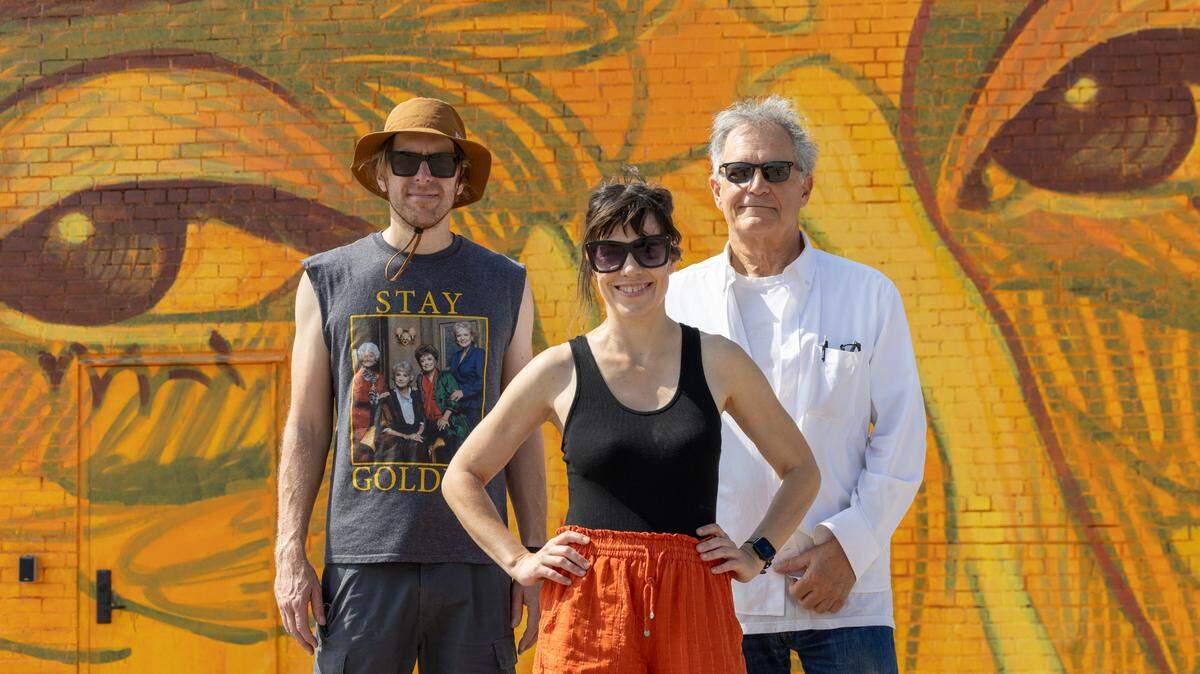 Midtopia CEO Jessie Hartke, center, and her husband, Adam, left, and John Salem stand outside a building at 235 N. Emporia that will be home to Midtopia’s new rehearsal space for musicians. The building will be part of this weekend’s Elsewhere Fest & Conference and then remain a rehearsal venue, which Salem will run.