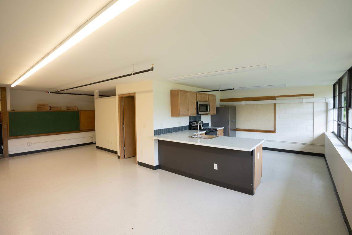 One of the converted apartments at the former Blackbear Bosin Academy, which includes one of the school’s blackboards.
