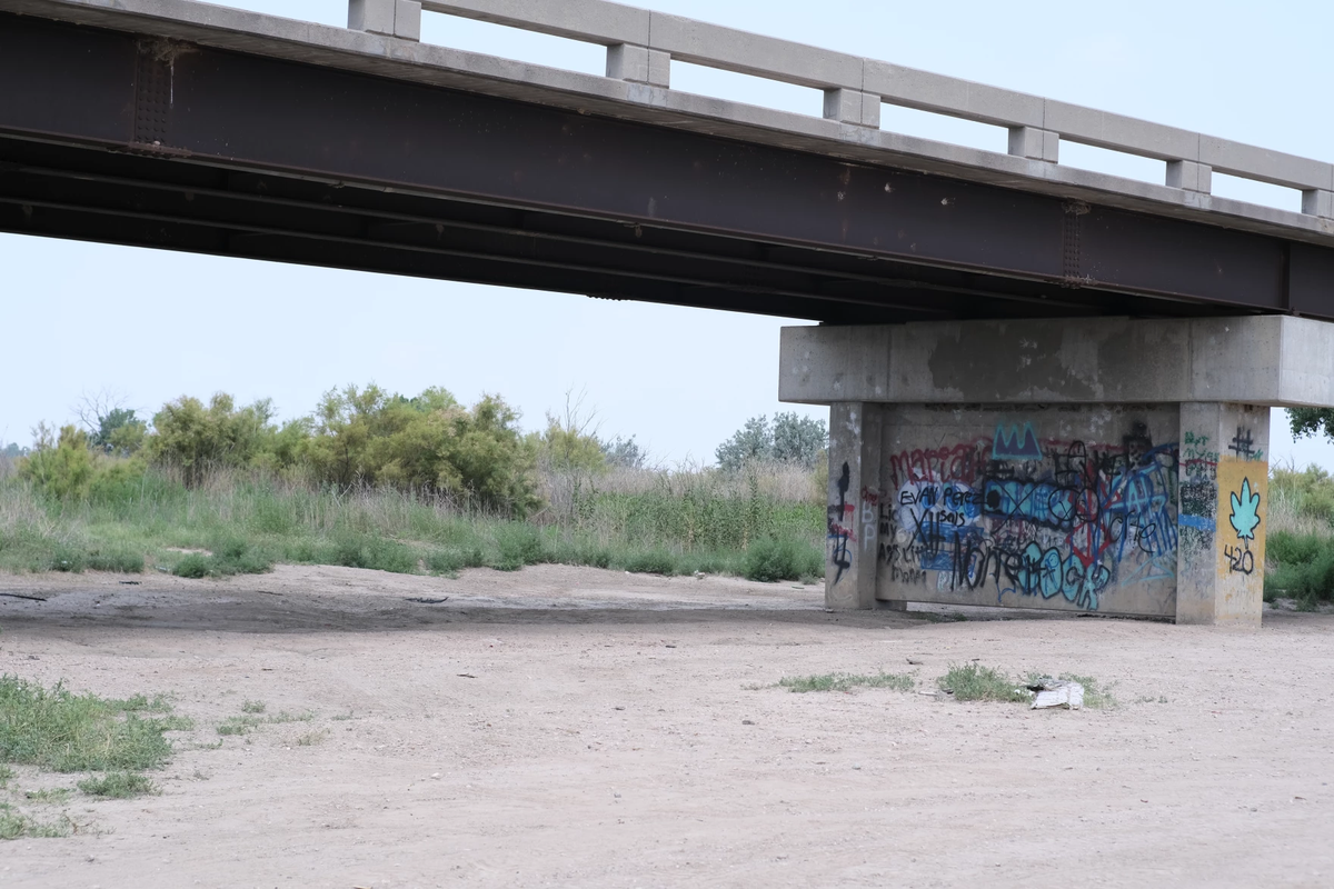 Spray paint covers the bridge over what used to be the Arkansas River in Lakin. The river has now been reduced to a dry bed for 150 miles due to pulling water from underground to irrigate.