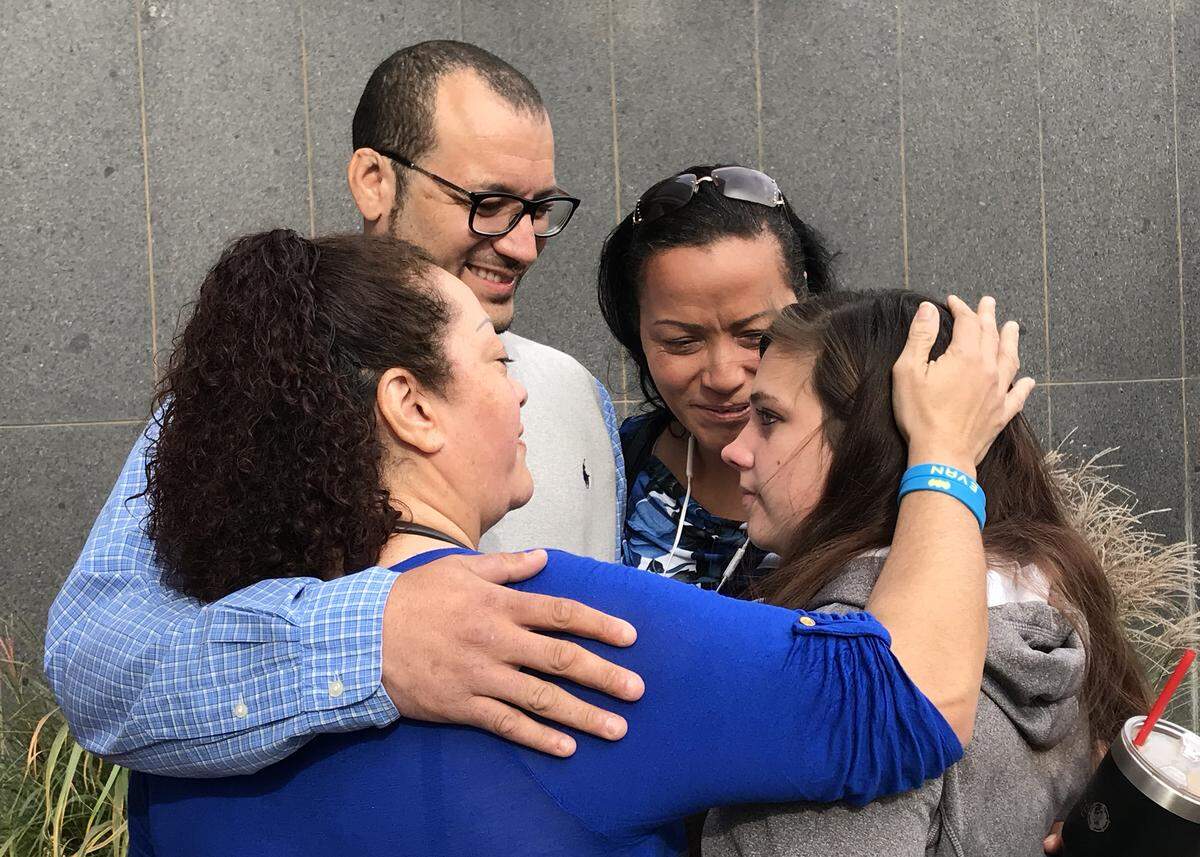 Carlo Brewer and his sisters Carol Brewer (blue top), Cheryl Brewer(center)  embrace Samantha Johnson, the daughter of Steven Bodine.  Bodine was convicted in the murder of 3-year-old Evan Brewer (Carlo’s son). Johnson became connected with the Brewers after suffering child abuse at the hand of her father Steven Bodine. 
