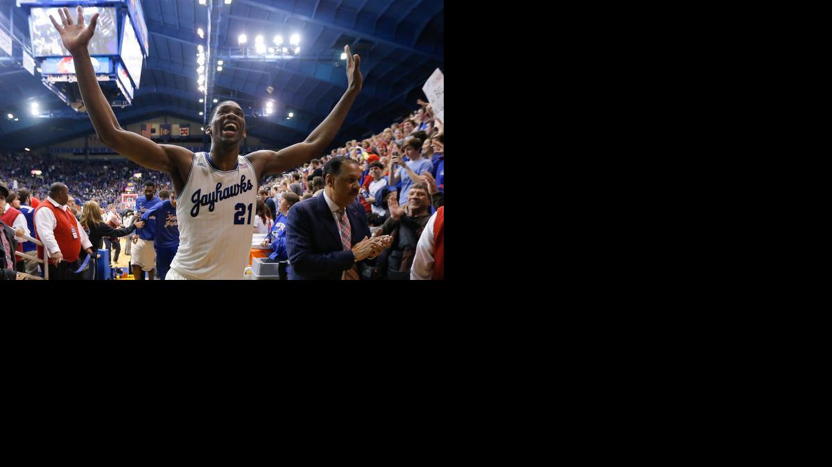 Joel Embiid holds up 10 fingers after Kansas clinched its 10th straight conference title in late February.


