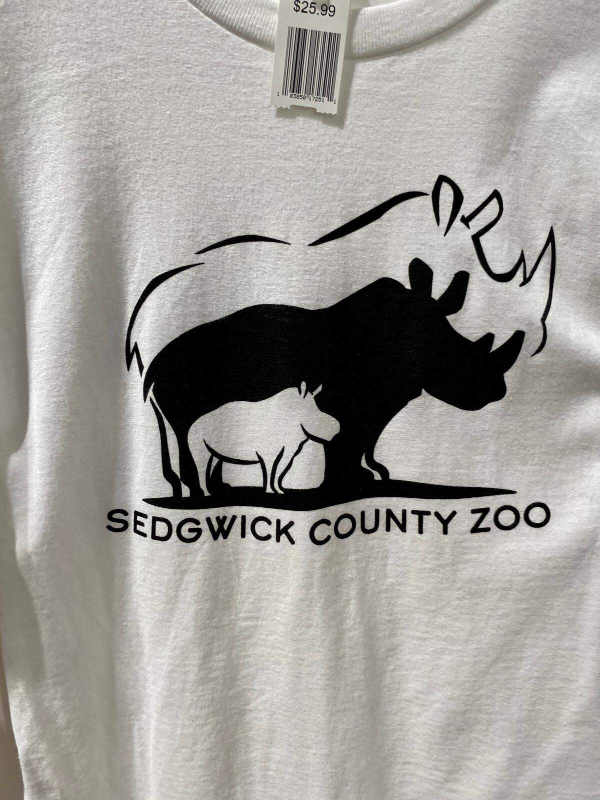 A special logo honoring KJ the rhino’s late father, Klyde, and his mother, Bibi, decorate shirts sold at the Sedgwick County Zoo gift shop.