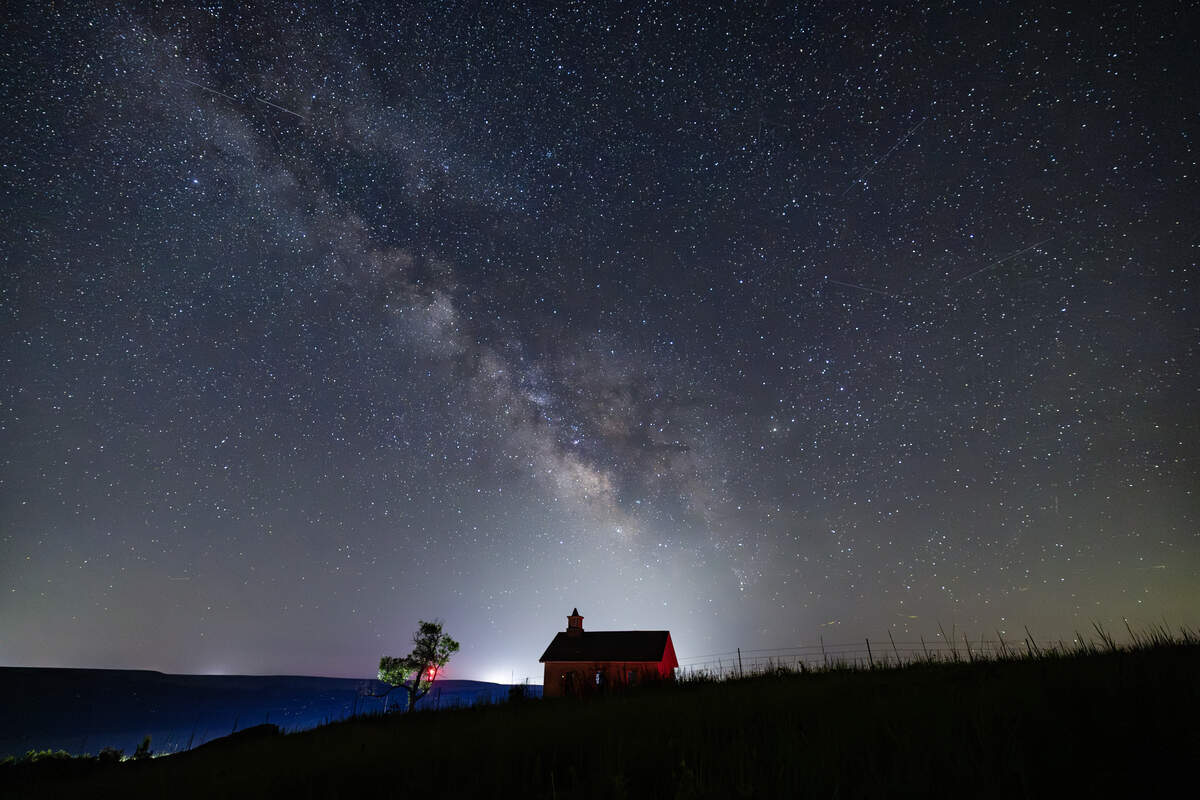 The Milky Way galaxy can be seen in the southern sky from the Lower Fox Creek Schoolhouse at the Tallgrass Prairie Preserve on Tuesday night. The galaxy is best viewed away from city lights in the summer, when the earth’s orbital position faces the galaxy’s star-filled core.