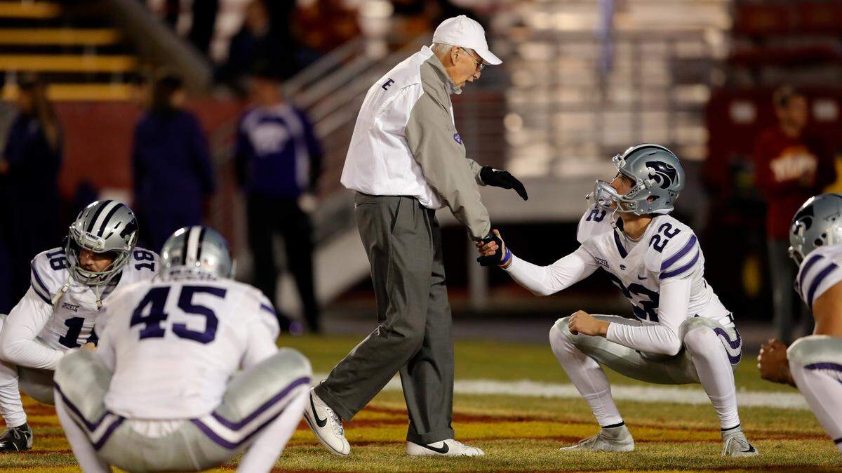 Kansas State head coach Bill Snyder greets place kicker Nick McLellan (22) before an NCAA college football game against Iowa State, Saturday, Nov. 24, 2018, in Ames, Iowa. (AP Photo/Charlie Neibergall)