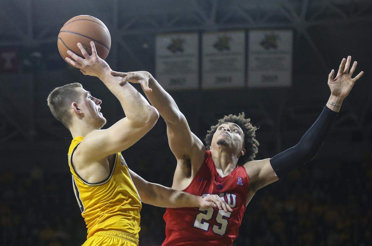 Wichita State guard Erik Stevenson is fouled by Southern Methodist forward Ethan Chargois during the second half of their game at Koch Arena on Wednesday.