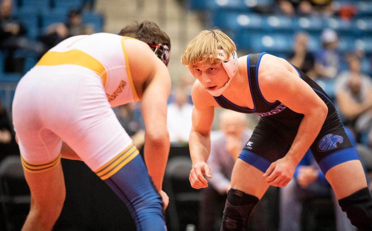 Goddard’s Jerrdon Fisher stares down his opponent in the Class 5A title match before winning his third straight state championship.