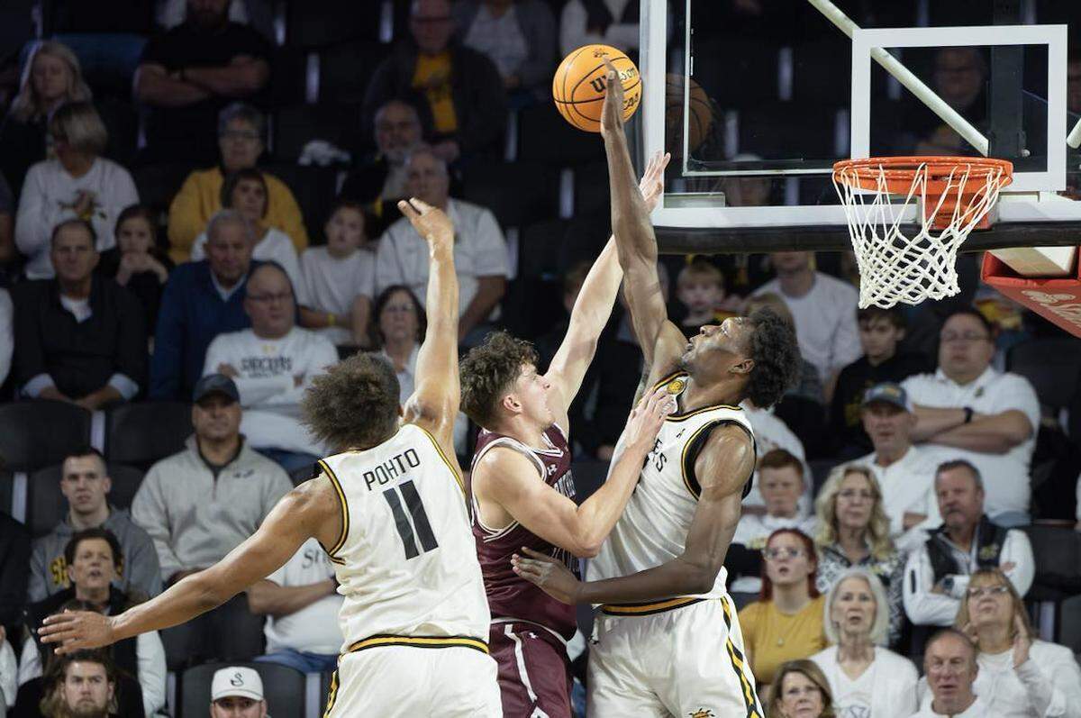 Wichita State’s Quincy Ballard blocks a shot by Southern Illinois in the first half of Saturday night’s game at Koch Arena.