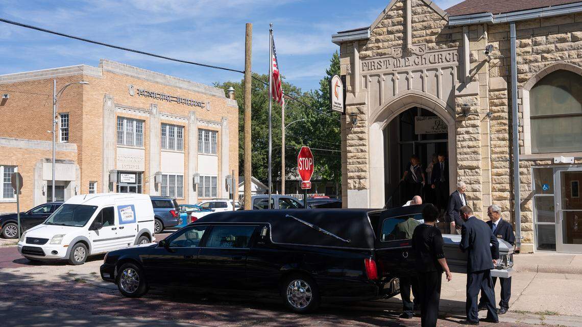 The first sign that something was going to be a little different about Joan Meyer’s funeral was the white, squat delivery vehicle advertising the Meyer family’s three community newspapers. The vehicle, which sat under the burning morning sun on a day projected to reach 110, was parked just feet from a long, black hearse in front of the church steps and later joined it in the procession to a graveside service.
