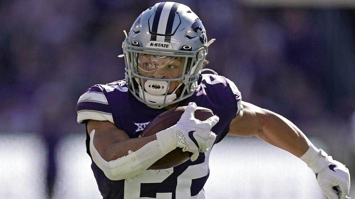 FILE - Kansas State running back Deuce Vaughn runs the ball during the first half of an NCAA college football game against TCU, Saturday, Oct. 30, 2021, in Manhattan, Kan. Vaugh was named to The Associated Press preseason All-America team, Monday, Aug. 22, 2022. (AP Photo/Charlie Riedel, File)