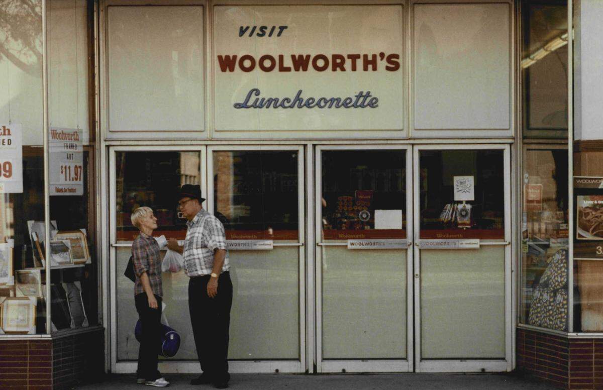 A picture from 1990 shows the “Try Woolworth’s Luncheonette” sign that once hung on the outside of the building at 205 E. Douglas.