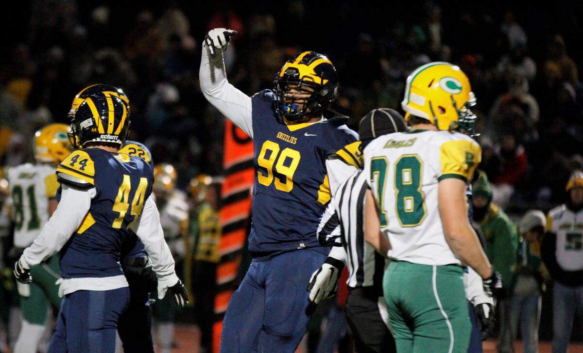 Marcus Hicks, a Wichita Northwest defensive end and Oklahoma verbal commit, gives the “Horns Down” after sacking Bishop Carroll quarterback Aiden Niedens.