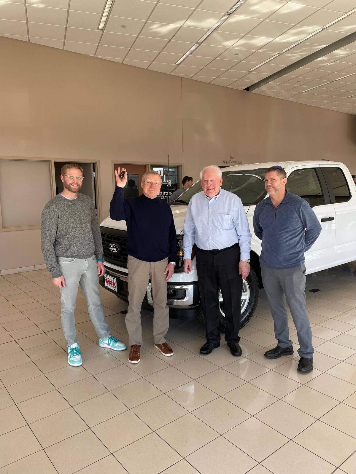 Bill Rosenboom, second from right, sold his 25,000th vehicle to longtime customer Mark Hutton, second from left. Also pictured is Hutton’s son, Ben, left, who is CEO of the family’s construction firm that’s also been a longtime customer. Also pictured is Kyle Eck, right. Rosenboom said the entire Rusty Eck Ford family has been great to him.