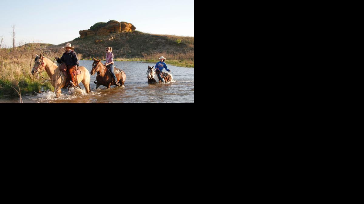 Riding the trails in around Kanopolis State Park can include touring rugged canyons and several water crossings, like this one being forded by Paula Avery, left, Ashley and Lacey Bowles Tuesday afternoon.


