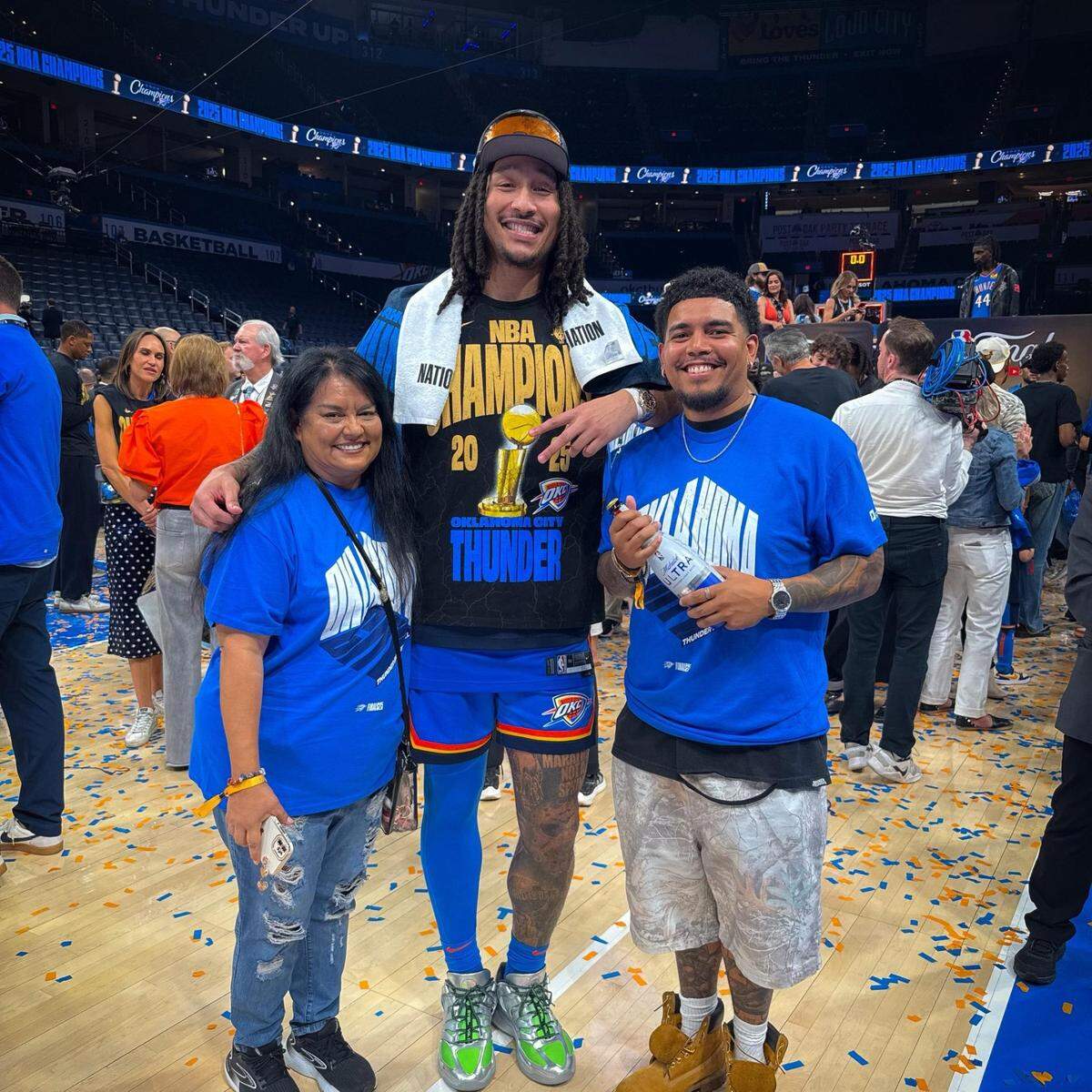 Wichita barber Michio Sanchez, right, poses with his mother and Oklahoma City player Jaylin Williams after the Thunder won the NBA championship earlier this month.