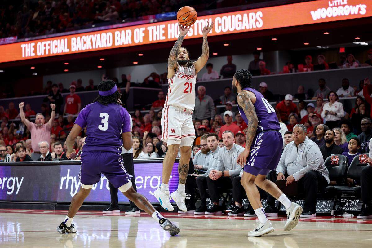 Emanuel Sharp #21 of the Houston Cougars takes a three-point shot in the first half against the Kansas State Wildcats at Fertitta Center on February 14, 2026 in Houston, Texas.