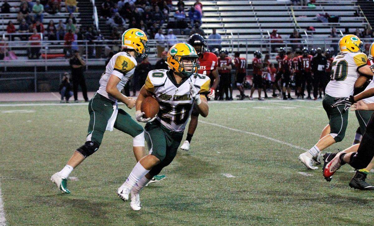 Jackson Nichols, a Bishop Carroll senior running back, looks for a hole against Wichita Heights in the Golden Eagles’ 36-20 win over the Falcons on Friday. (Sept. 7, 2018)