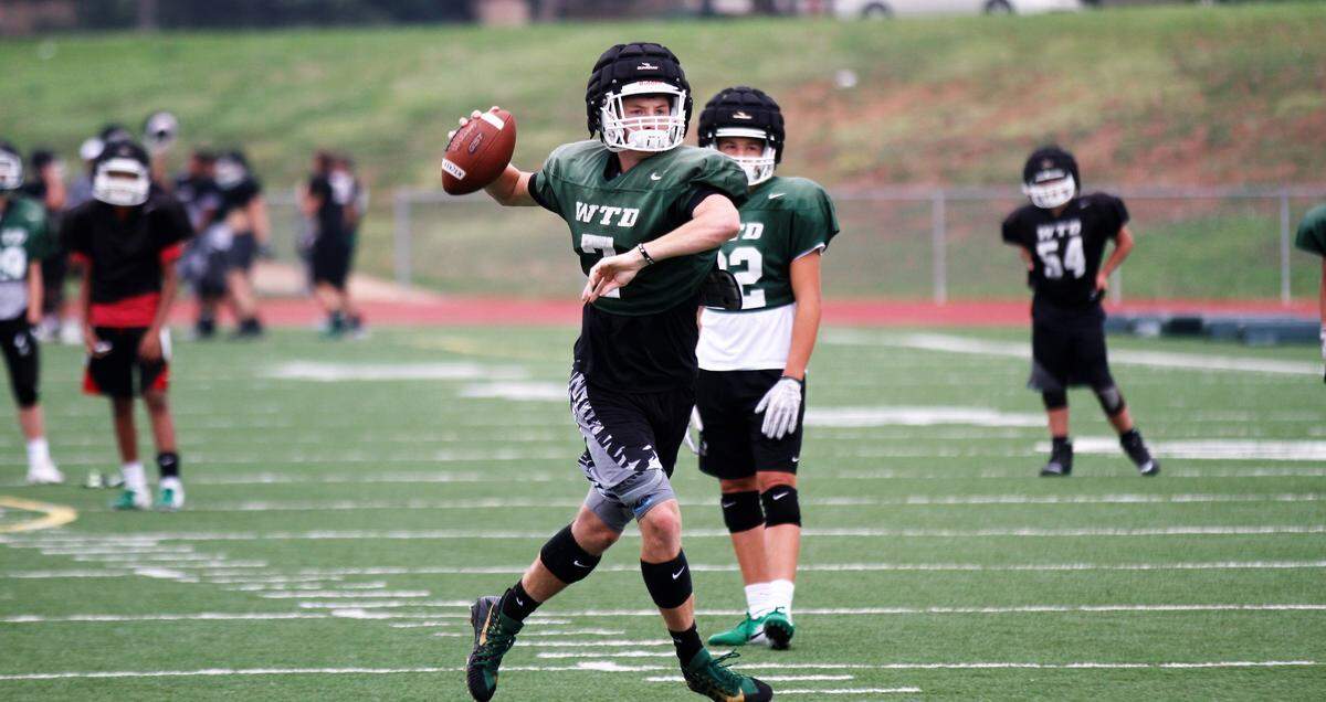 Derby’s Grant Adler looks for a receiver downfield during the Panthers’ fall practice.