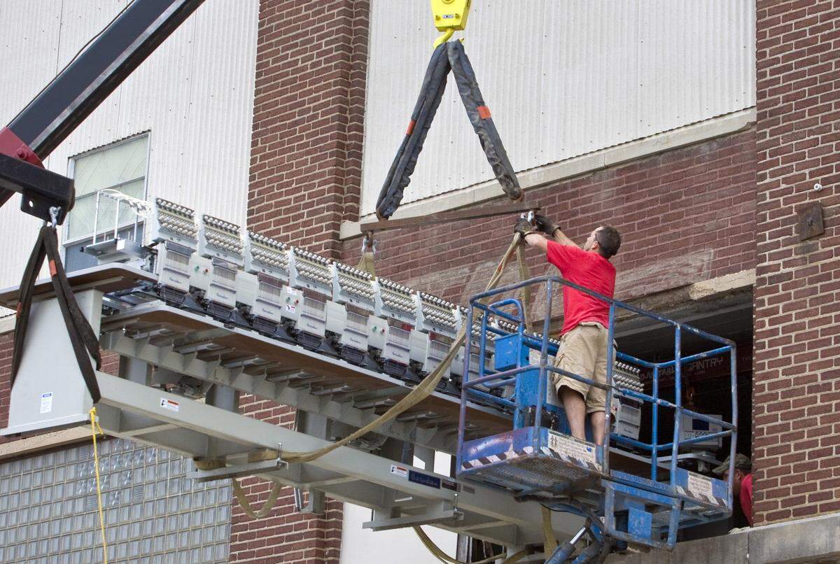 When Industrial Uniform and Logo Depot moved out of its headquarters at 906 E. Waterman in 2009, it had to get an embroidery machine out using a crane.