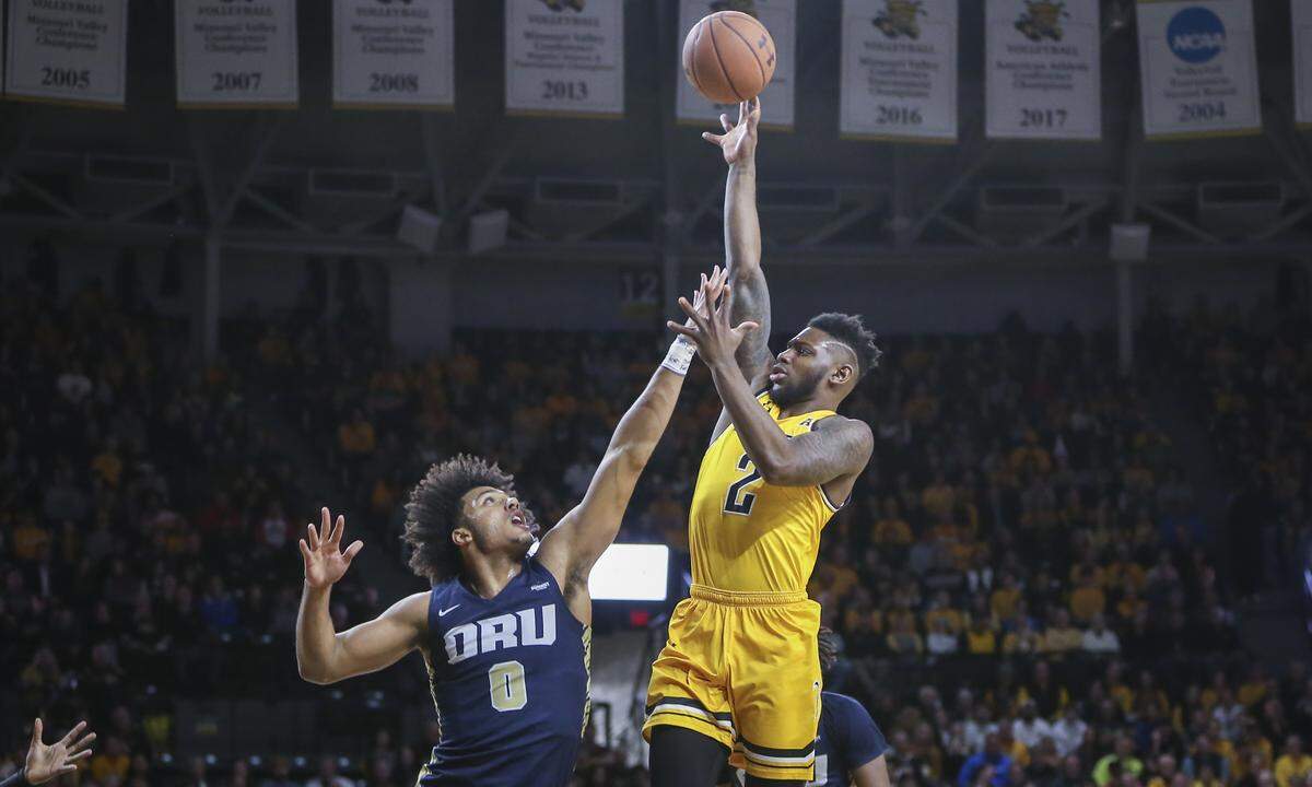 Wichita State’s Jamarius Burton makes a shot over Oral Roberts’ Kevin Obanor at Koch Arena on Saturday.