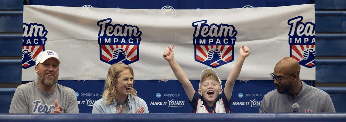 Ryker Ammons, 10, celebrates after signing his letter of intent to become an honorary member of the Newman Jets’ basketball team. The signing event was organized by Team IMPACT, a national nonprofit that connects children facing serious or chronic illnesses with college athletic teams.