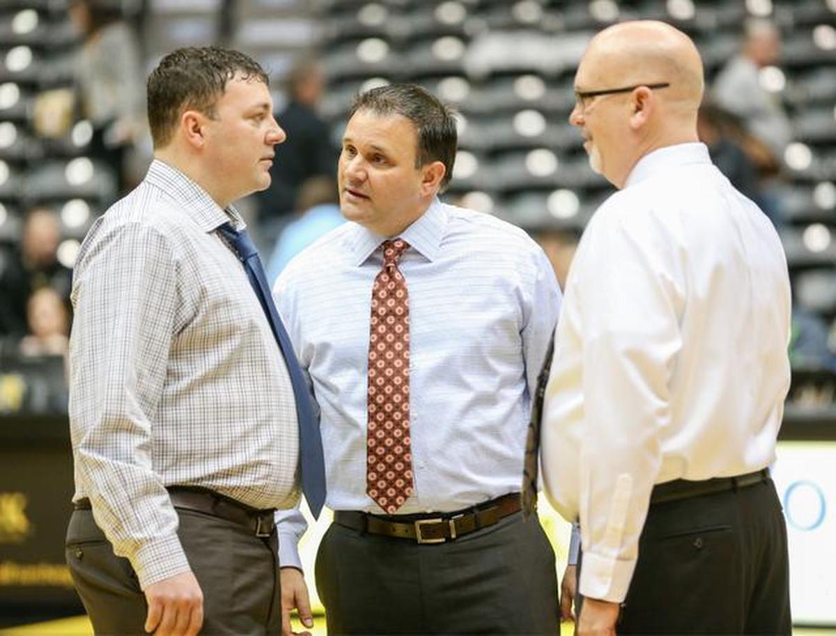 WSU assistant coaches Greg Heiar, left, Chris Jans and Steve Forbes talk prior to the March 1 Missouri State game. All are from Iowa with junior-college coaching backgrounds.
