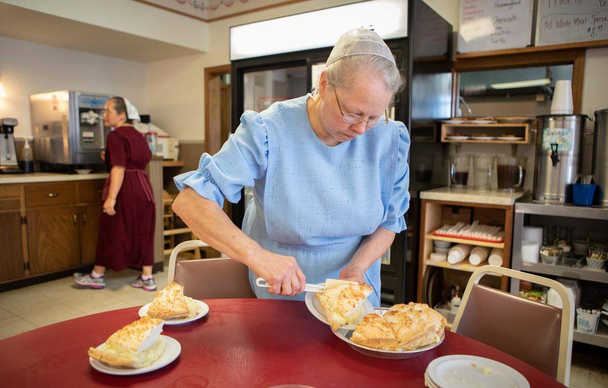 Carolyn Bontrager prepares servings of pies in her restaurant, Carolyn’s Essenhaus, in downtown Arlington. Bontrager has been running the small-town cafe for 30 years.