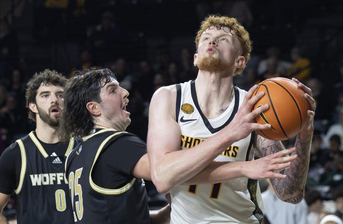 Wichita State’s Will Berg is fouled by Wofford’s Rex Stirling on Wednesday night at Koch Arena.