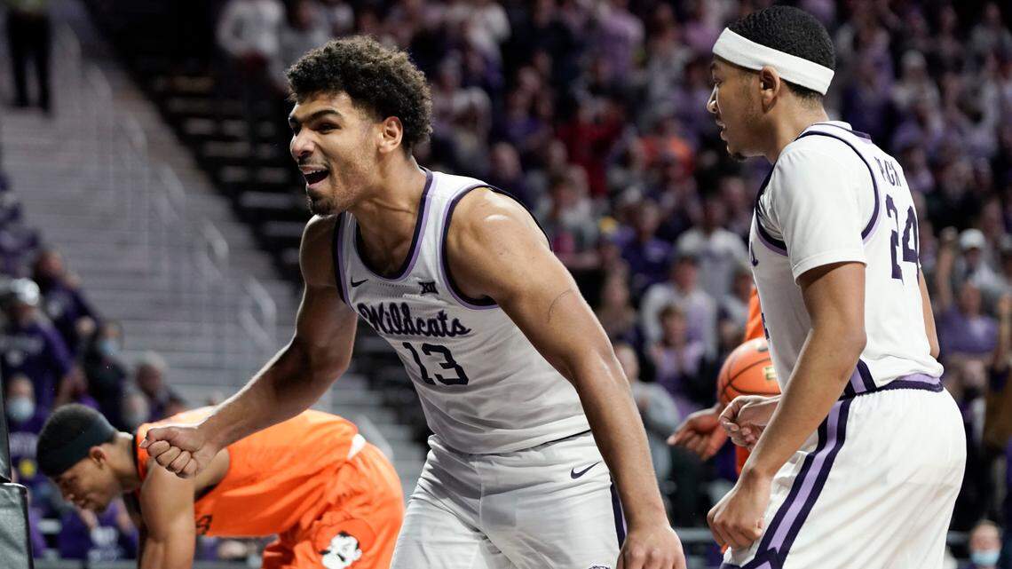 Kansas State guard Mark Smith (13) and Kansas State guard Nijel Pack (24) celebrate a basket by Smith against Oklahoma State during the second half of an NCAA college basketball game on Wednesday, Feb. 2, 2022, at Bramlage Coliseum in Manhattan, Kan. Kansas State defeated Oklahoma State, 71-68. (AP Photo/Nick Krug)