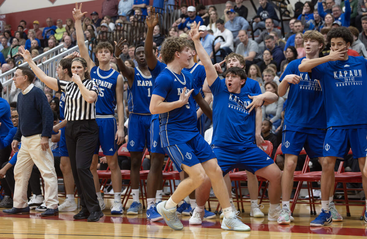 The Kapaun bench reacts to Cole Rapp’s three pointer during the second half against Collegiate on Monday night at Friends University.