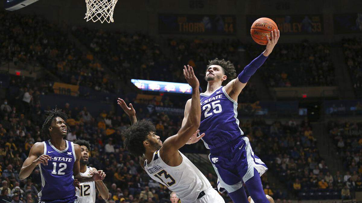Kansas State forward Ismael Massoud (25) shoots over West Virginia forward Isaiah Cottrell (13) during the first half of an NCAA college basketball game in Morgantown, W.Va., Saturday, Jan. 8, 2022. (AP Photo/Kathleen Batten)