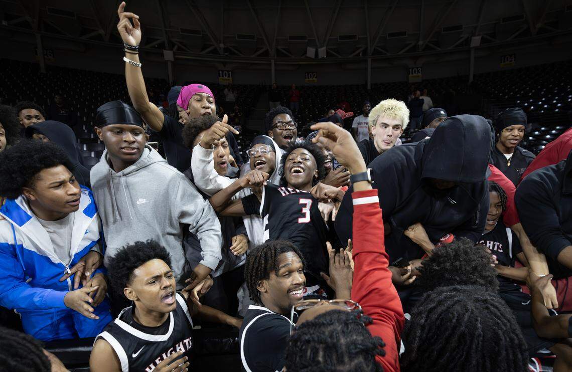 Heights players celebrate with classmates and fans after they defeated Maize by one point in the 6A quarter final game at Koch Arena on Wednesday.