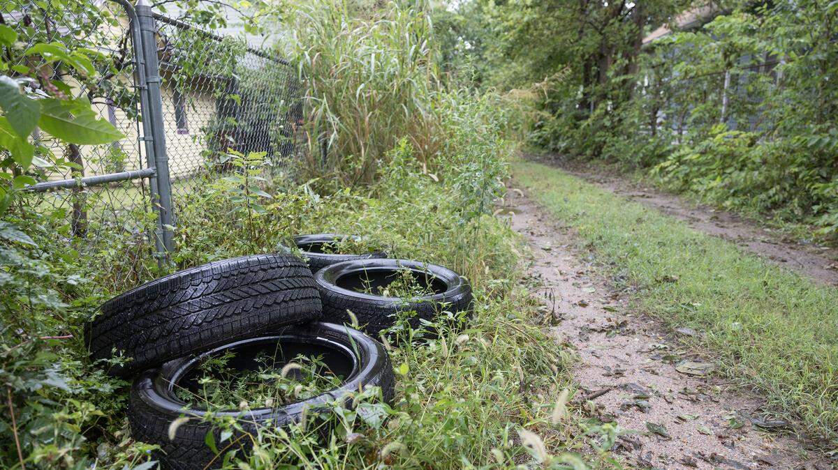 A pile of tires lies in a Delano alleyway after being dumped there.