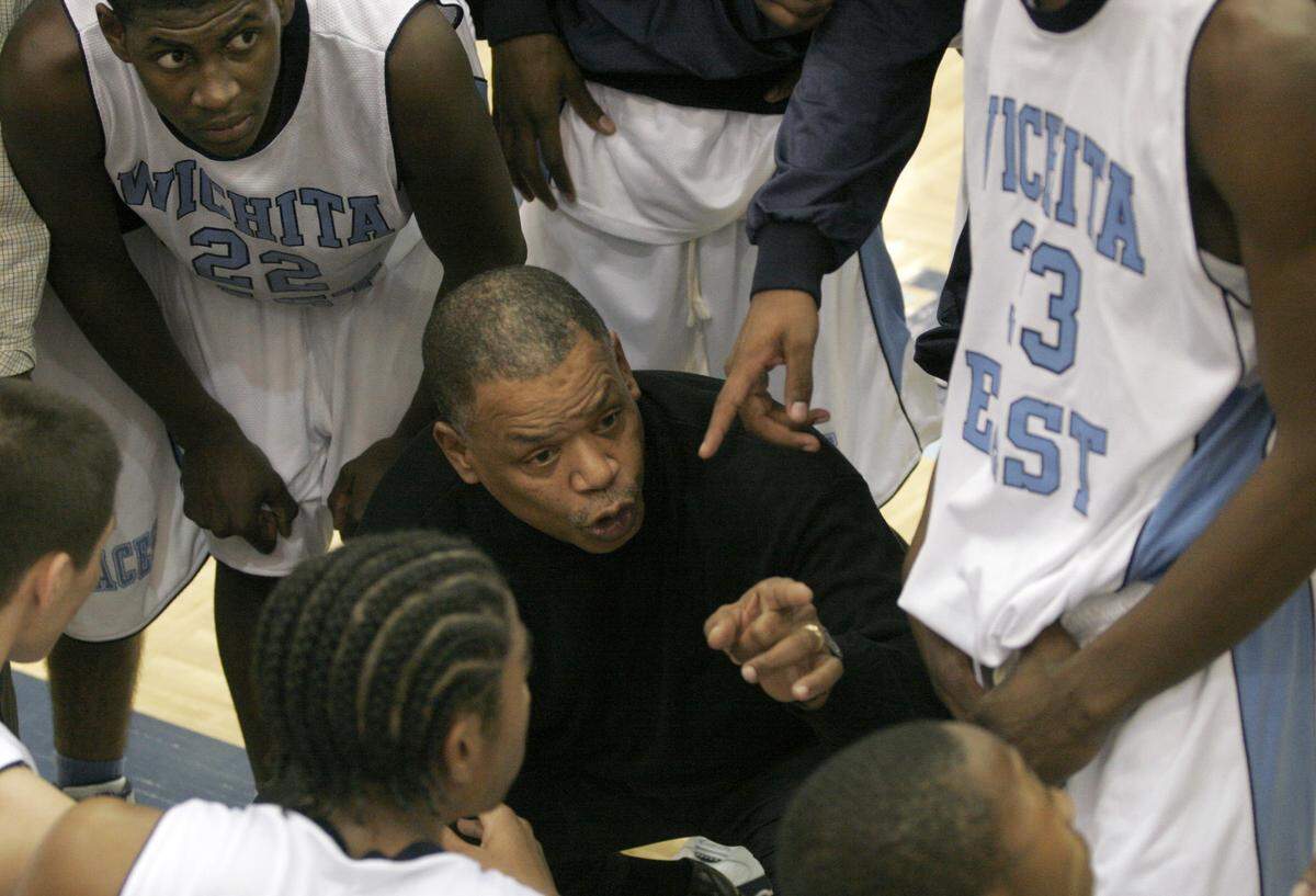 East coach Ron Allen gives his team instructions during a huddle. The legendary City League figure died at the age of 71 in December 2022.