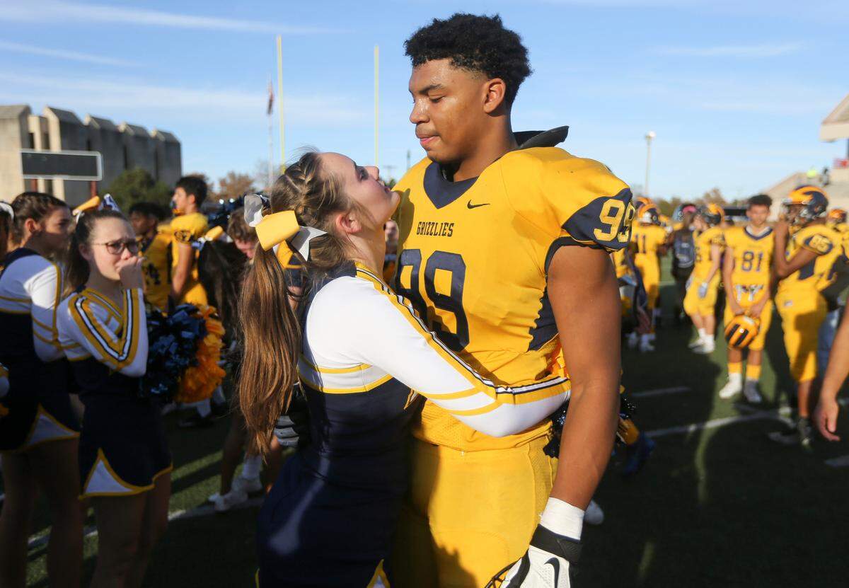 Wichita Northwest’s Marcus Hicks is consoled by his girlfriend after the Grizzlies lost the 5A title to St. Thomas Aquinas on Saturday in Pittsburg. 