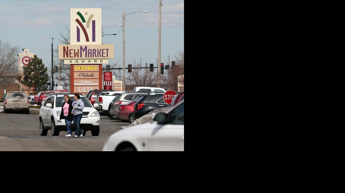 People visit the NewMarket Square shopping center in northwest Wichita.

