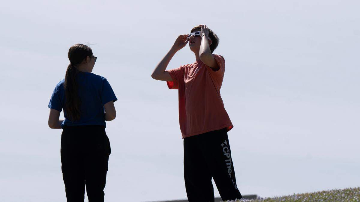 Several hundred people attended an eclipse party at Exploration Place Monday. Many got there early and hiked up the hill on the northeast corner of First and McLean to take a look at the sun before the peak of the eclipse at 1:48 p.m.