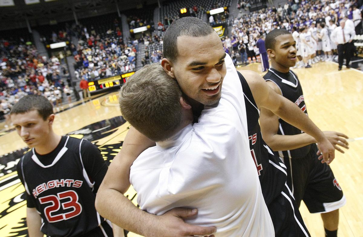 Heights' Perry Ellis gets a hug from coach Joe Auer after the Falcons defeated BV Northwest 67-60 in the Class 6A championship game at the state basketball tournament at Koch Arena in Wichita, Kan., Saturday. (March 10, 2012)