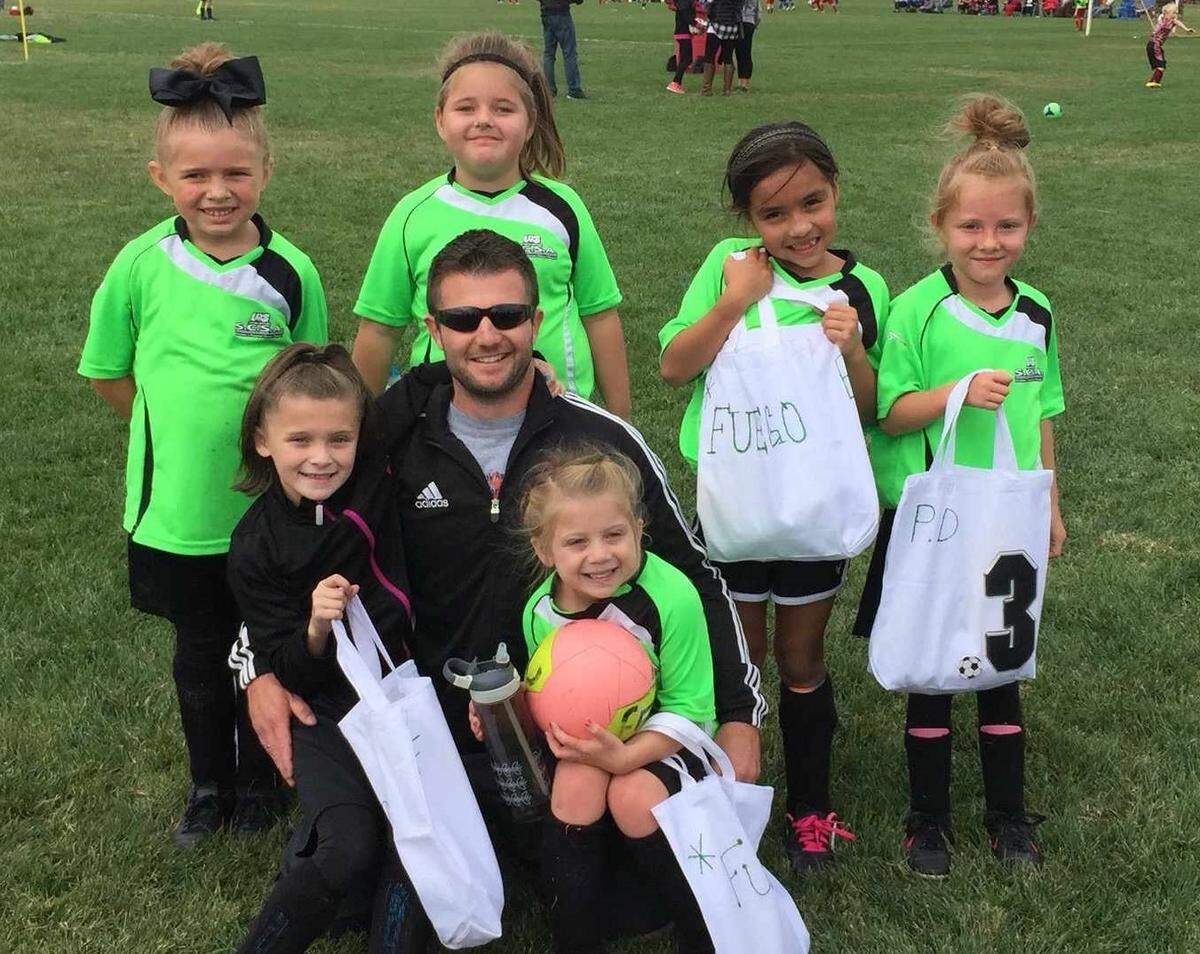 Thomas Doyle coached soccer for all three of his daughters. Included in this 2015 photo is his daughter Marlie (sitting in his lap wearing green), niece Ariana Fox (also in his lap) and Cassie Steiner (back left), the daughter of Doyle’s childhood friend.