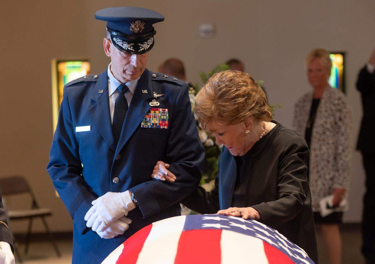 Former North Carolina Sen. Elizabeth Dole pauses before the casket of her husband, former Kansas Sen. Bob Dole, after a memorial service at St. Mary Queen of Angels Catholic Church in Russell, Kansas, on Saturday. Bob Dole was the Republican presidential nominee in 1996 and former Senate majority leader. He died Dec. 5 at age 98.