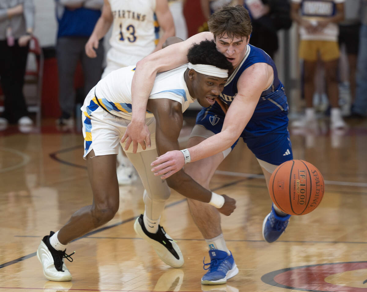 Collegiate’s Sebastian Hines-Turner, left and Kapaun’s Blaise Dalian collide while chasing a loose ball during the second quarter on Monday night at Friends University.