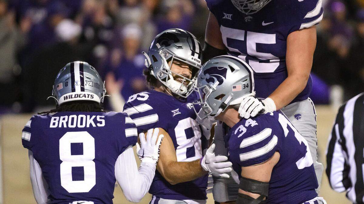 Kansas State wide receiver Kade Warner (85) celebrates with teammates wide receiver Phillip Brooks (8), tight end Ben Sinnott (34) and offensive lineman Hayden Gillum (55) after scoring a touchdown against Texas during the second half of an NCAA college football game Saturday, Nov. 5, 2022, in Manhattan, Kan. (AP Photo/Reed Hoffmann)