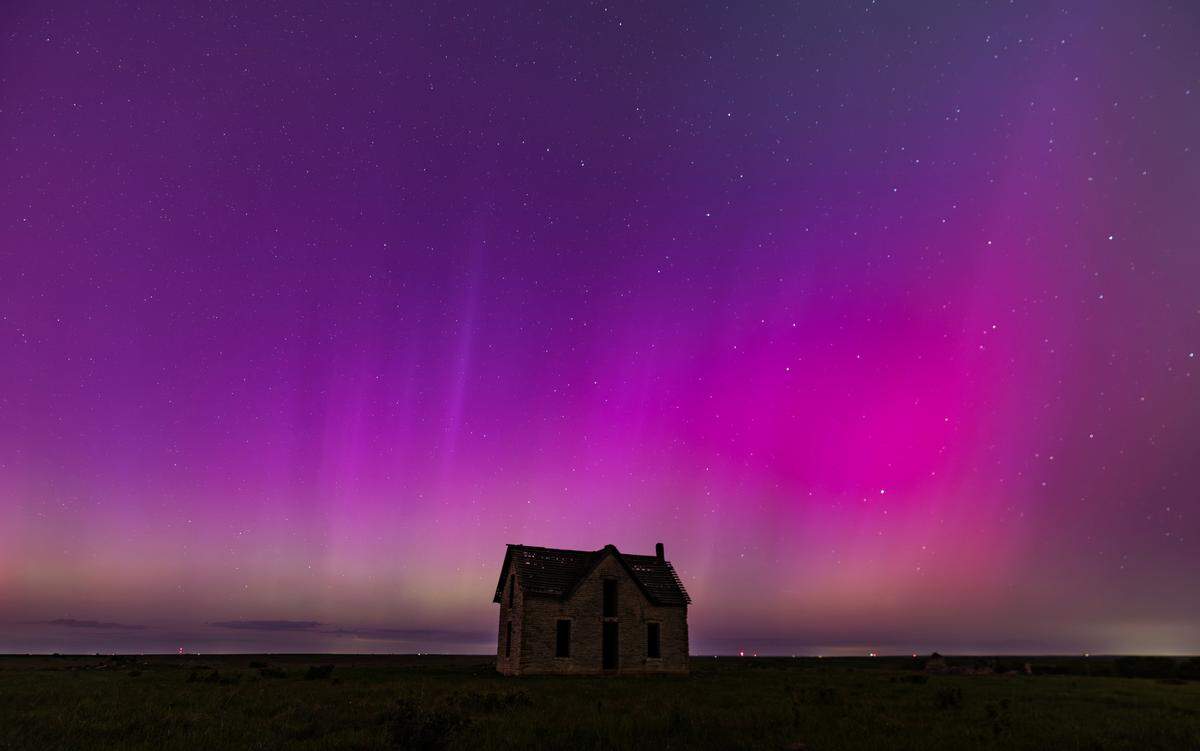 The aurora borealis can be seen in the northern sky near the Marion and Chase County line on Friday night. The abandoned stone limestone house in the pasture was built in 1878.