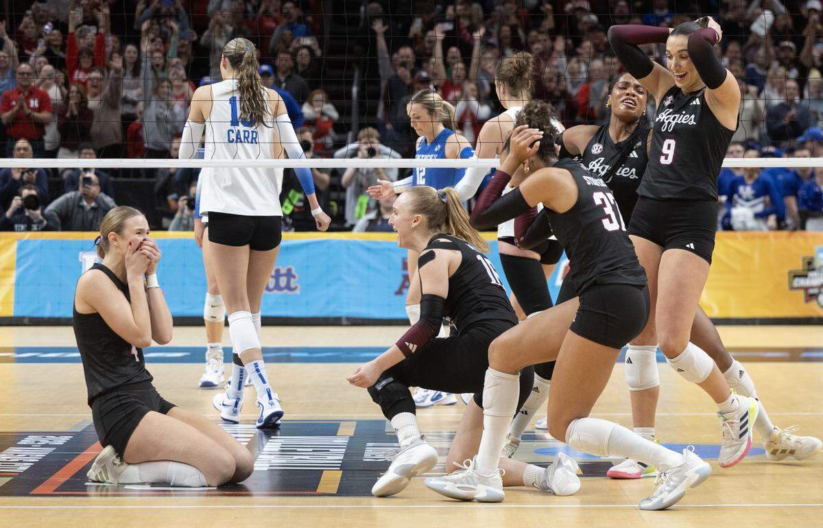 Texas A&M players celebrate finishing a sweep of Kentucky in the championship match of the NCAA Volleyball Championship on Sunday afternoon at the T-Mobile Center.