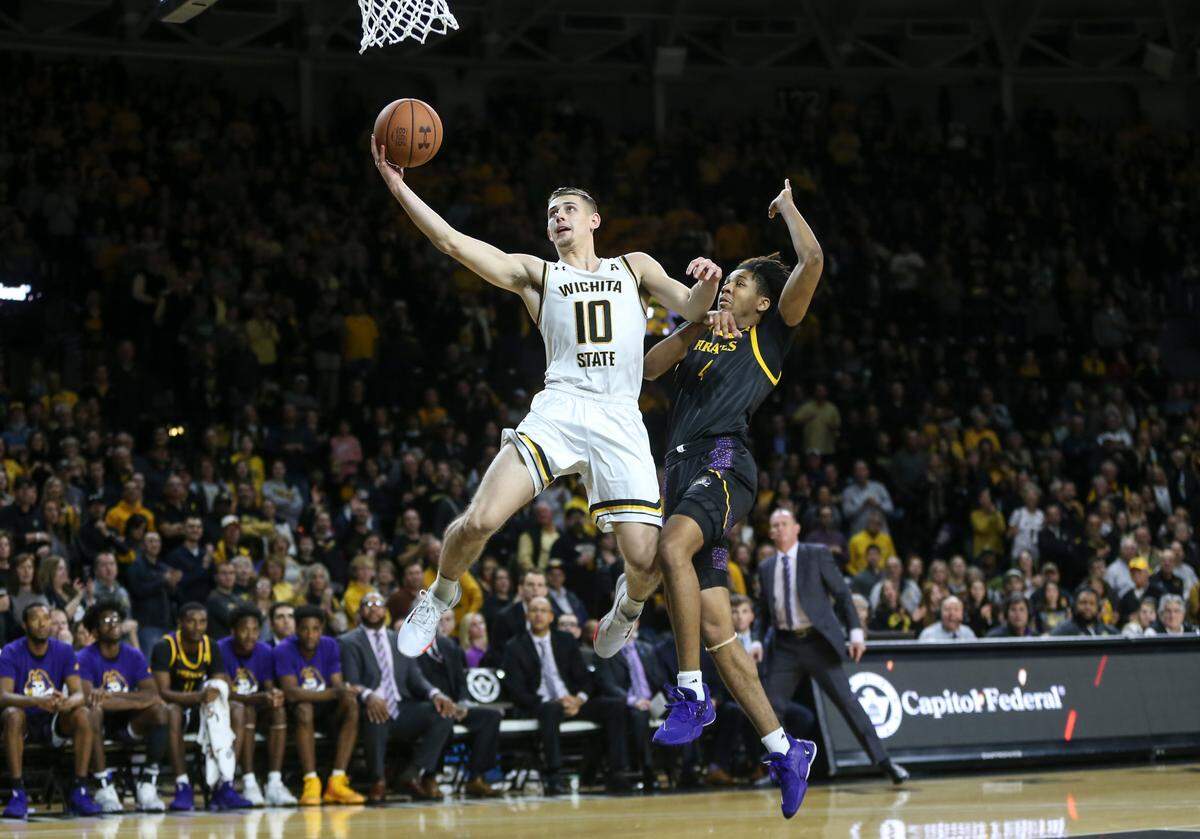 Wichita State’s Erik Stevenson makes a breakaway basket against East Carolina’s Brandon Suggs during the first half of their game at Koch Arena on Wednesday.