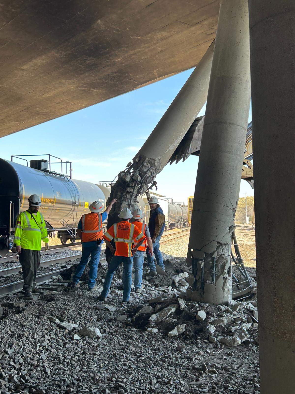 Crews assess damage to I-135 bridge columns after a March 20 derailment on a nearby Union Pacific line.