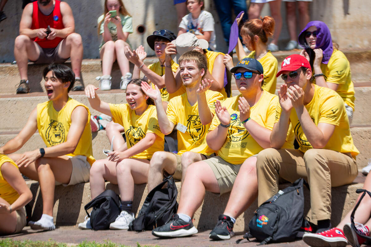 Prairie Schooner Mates cheer on their teammates on the Arkansas River, who are competing in the cowboy bathtub races on Saturday.