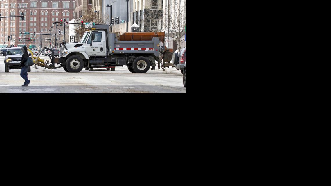 A snowplow scatters sand on Douglas at Main on Thursday. (Feb. 6, 2014)

