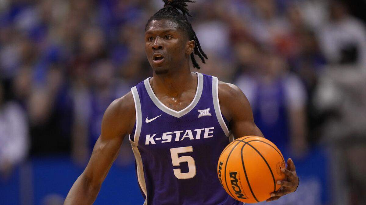 Kansas State guard Cam Carter looks to pass during the second half of an NCAA college basketball game against Kansas Tuesday, Jan. 31, 2023, in Lawrence, Kan. Kansas won 90-78. (AP Photo/Charlie Riedel)
