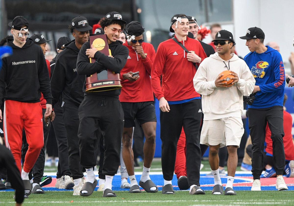 Sophomore forward Jalen Wilson carried the National Championship tropy as the Jayhawks arrived home Tuesday, April 5, 2022, to Booth Memorial Stadium after the team defeated North Carolina, 72-69, to claim the NCAA National Championship in New Orleans on Monday, April 4, 2022.